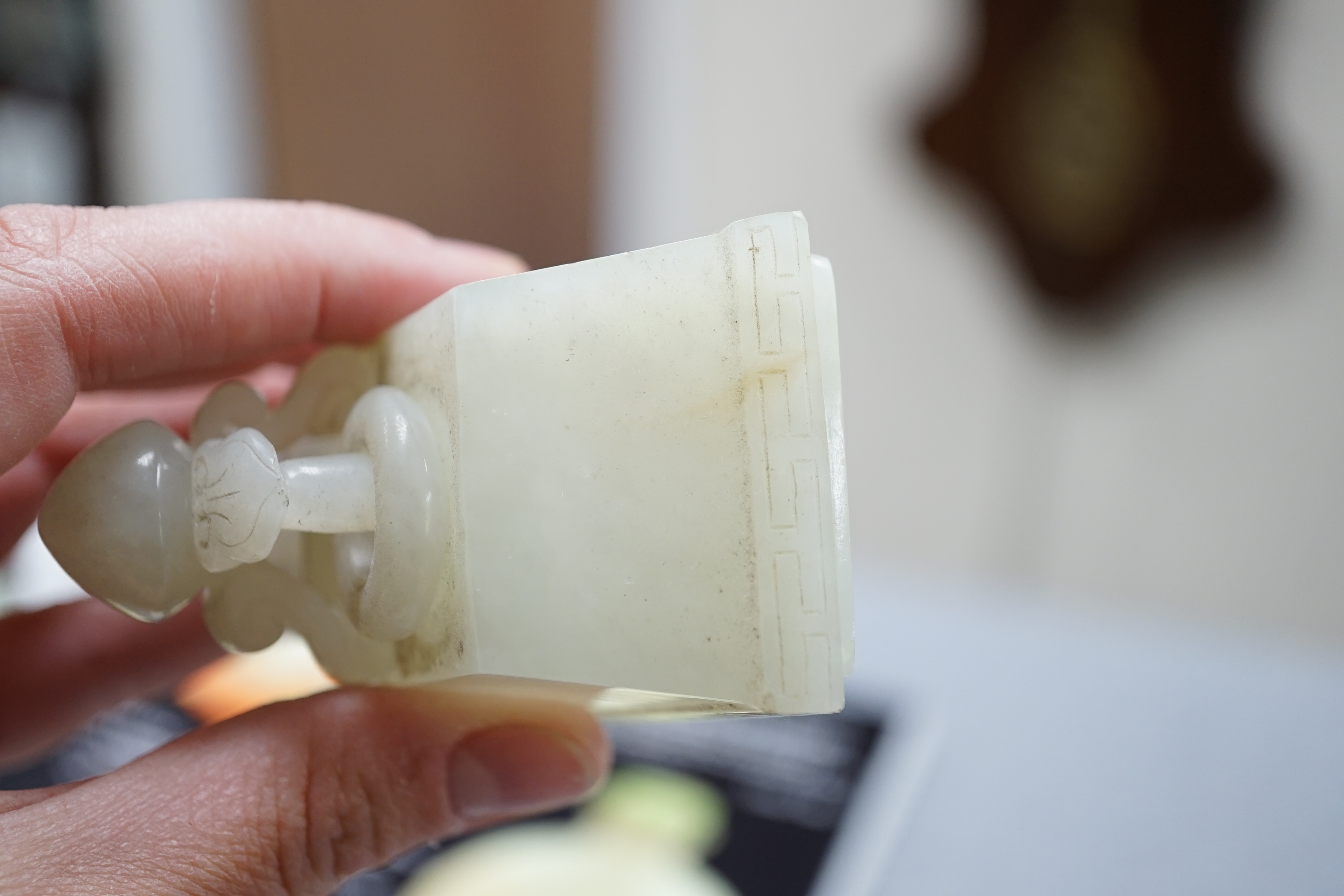 A Chinese pale celadon jade rectangular vase and cover, 19th/20th century
